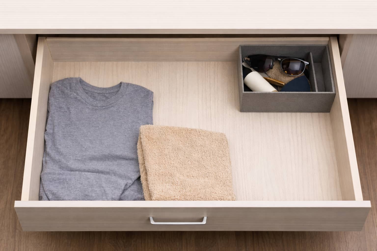 A half-empty drawer with loose spacing and fewer items, still tidy.